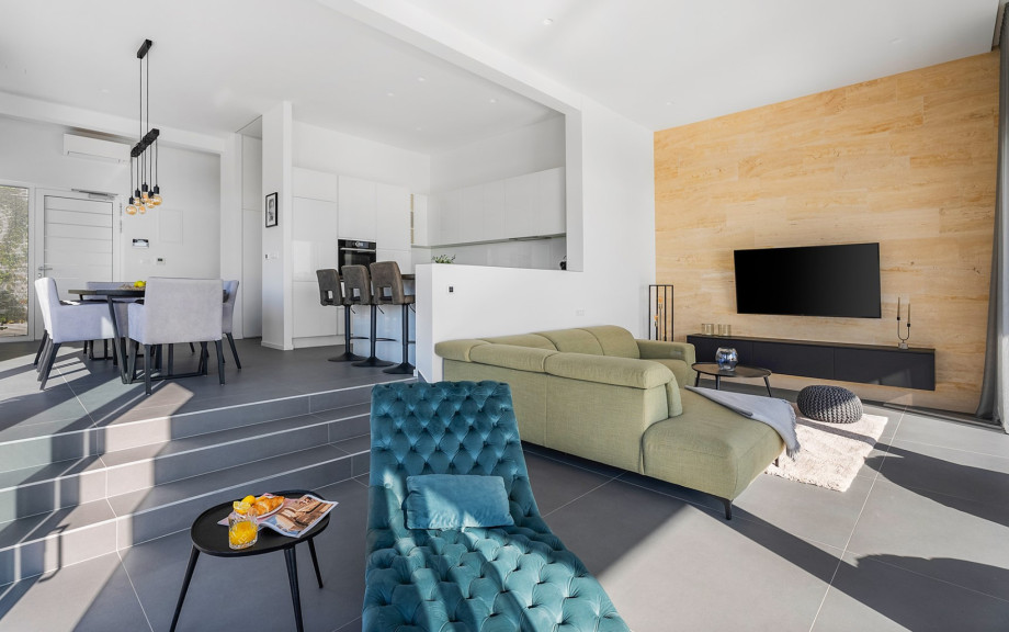 An open-plan living area that includes a stylish and fully equipped kitchen with all the amenities a modern guest