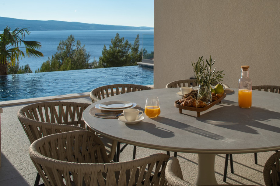 Enjoy a meal at the outdoor dining area with a gorgeous view of the heated infinity pool.