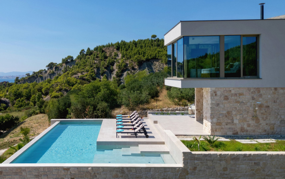 Modern villa exterior, featuring a private pool and a shallow part with hydromassage features.