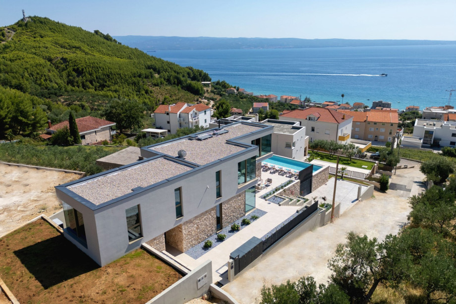 Aerial view showing the two-level Villa St. Christopher nestled in a peaceful area above the coastal road.