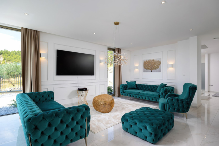 The spacious living room invites relaxation with plush sofas and a flat-screen TV.
