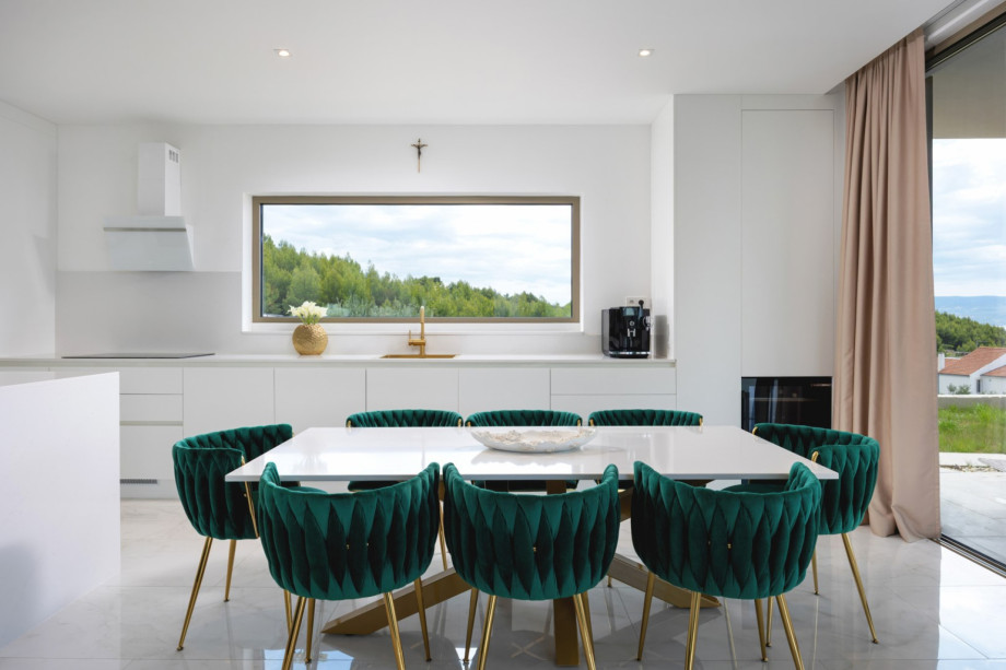 The stylish dining area comfortably seats 8 guests next to the fully equipped modern kitchen.