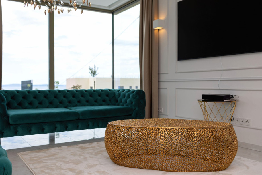 Close-up of the stylish living room with plush sofas and a flat-screen TV for relaxation.