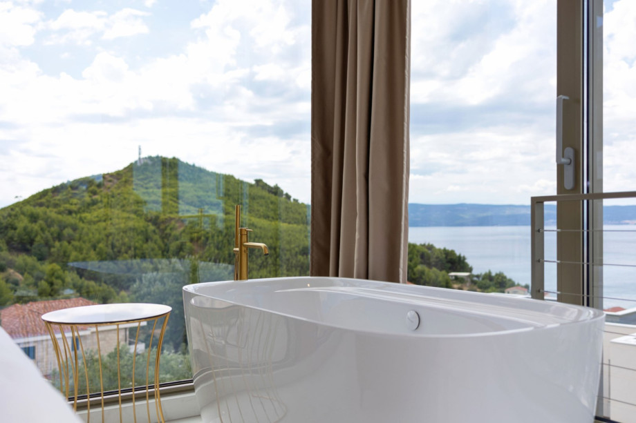 Freestanding bathtub in Bedroom 1 (30 sqm) offering a perfect spot to enjoy the spectacular sea views.