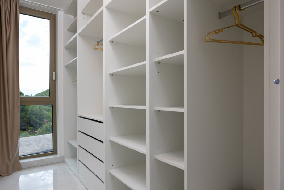 Walk-in wardrobe in Bedroom 1 (30 sqm), providing ample storage for clothes and belongings.