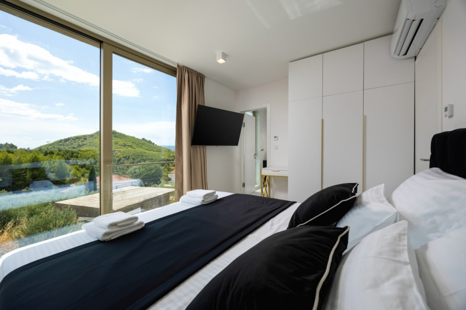 Bedroom 2 (East-facing) features a King-size bed (180cm x 200cm) and views of the natural surroundings.