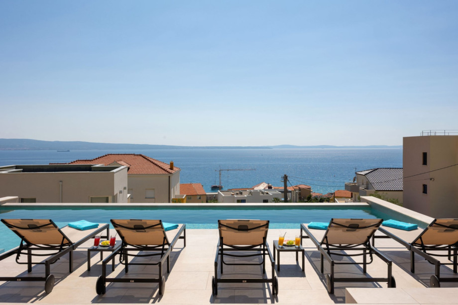 The 50sqm private heated swimming pool with sun deck offers magnificent views of the sea and neighborhood.