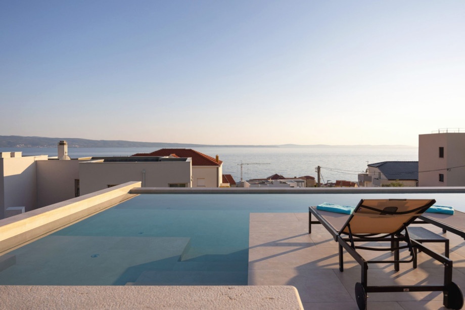 The private heated swimming pool includes a shallow part (14 sqm) with hydromassage features.