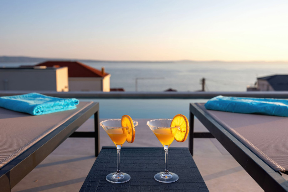 Sun loungers beside the private pool offer a relaxing spot to enjoy the sea view.