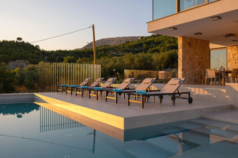 The sun deck holds 6 deck chairs next to the 50sqm private heated swimming pool, ideal for relaxation.