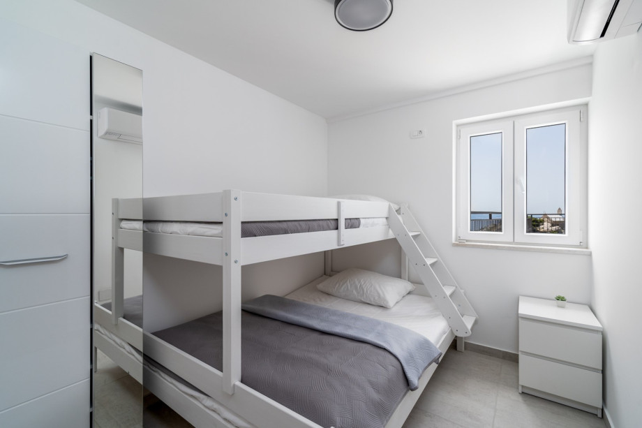 Bedroom No2 (8sqm) with a bunk bed with one bed size is140cm x 200cm, and the one above is 90cm x 200cm