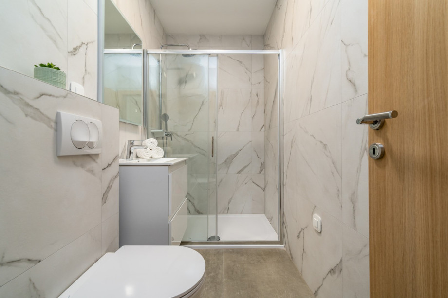 A separate family bathroom with a shower.