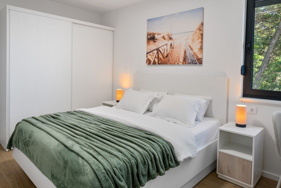 Bedroom NO2 (12 sqm) has an air-conditioned, TV, a king-size bed measuring 180 cm by 200 cm