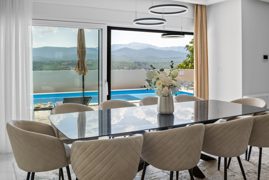 Dining table for 10 with sliding glass doors toward the pool area