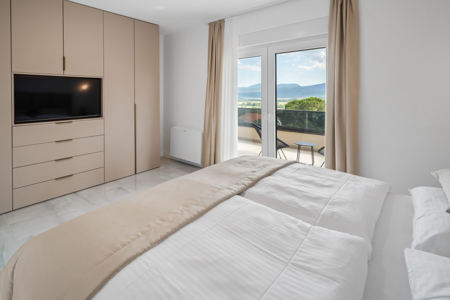 Bedroom No. 2 Is fully air-conditioned, equipped with a TV and an en-suite bathroom with a shower.