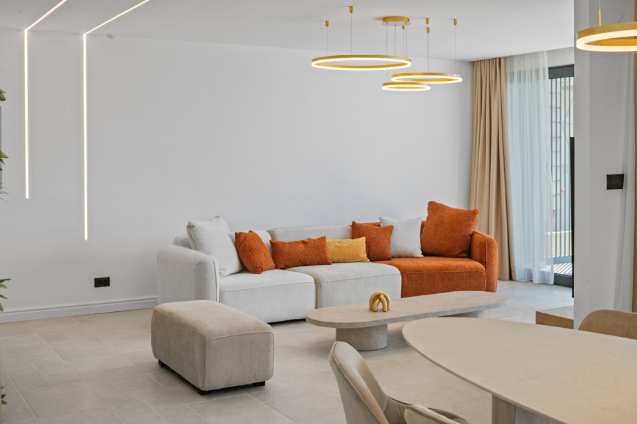 Open-plan living/dining area with large glass doors to pool terrace