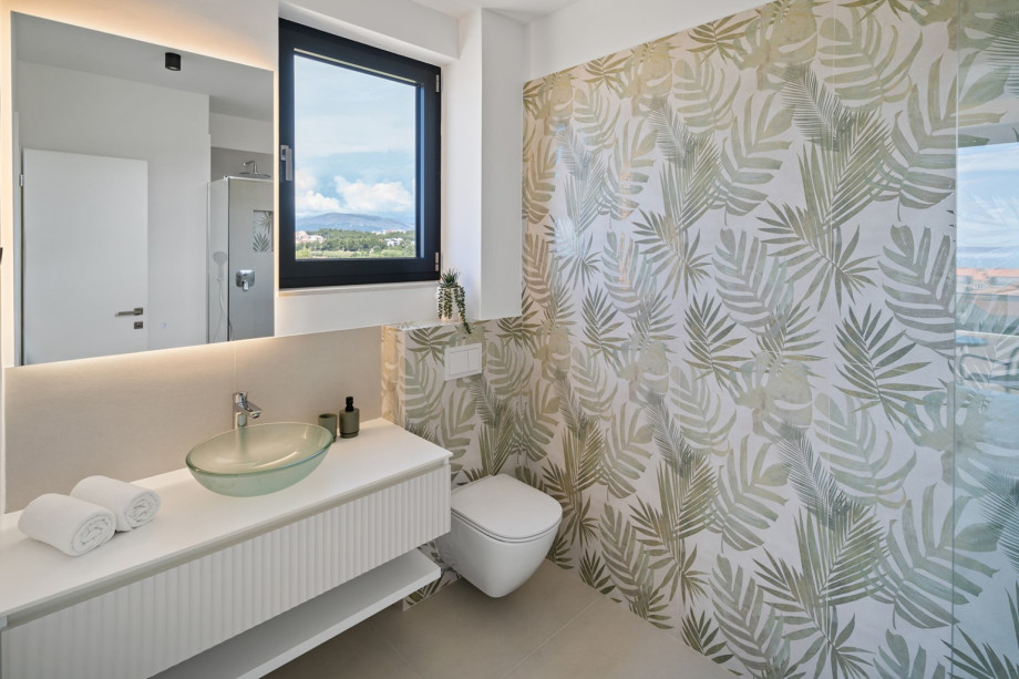 An en-suite bathroom with a shower, a sink, and a toilet