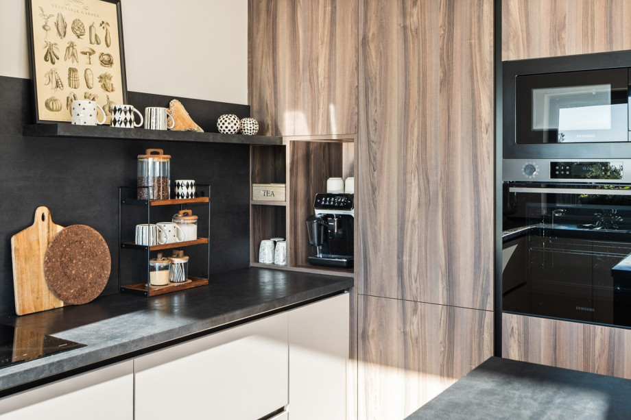 Built-in appliance area of the kitchen, highlighting the Nespresso coffee machine, microwave, and ample storage.