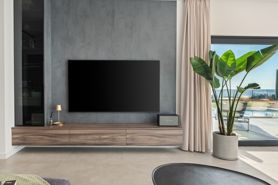 Part of the air-conditioned living room, featuring a flat-screen TV for cosy movie nights.