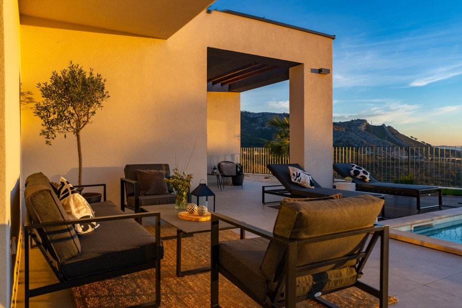 Charming lounge corner on the sun terrace, perfect for unwinding and enjoying the golden hour views.