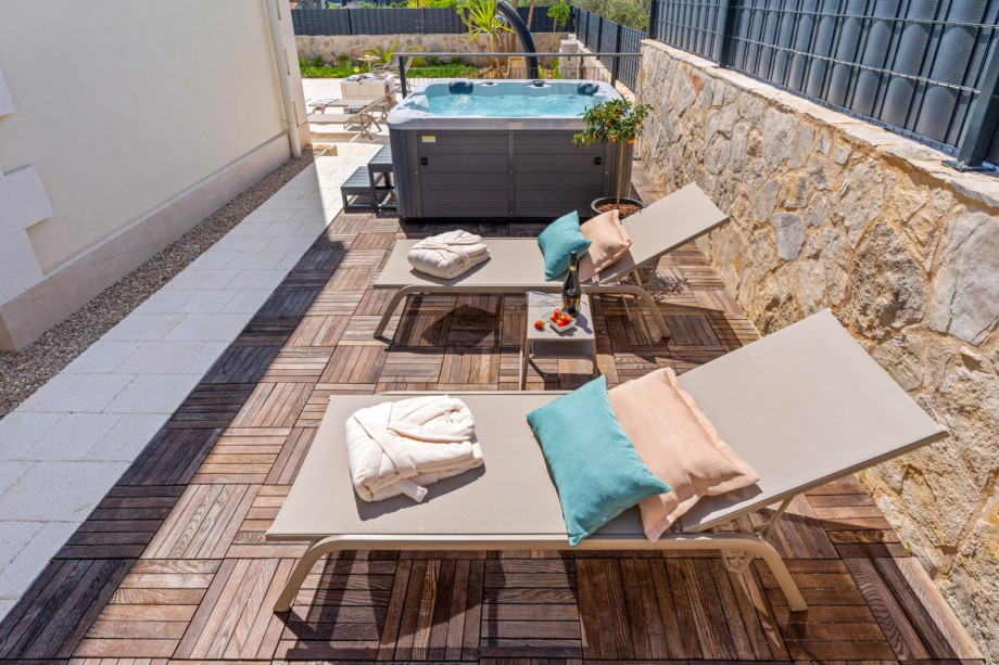 A sun deck with a jacuzzi for only your relaxing time.