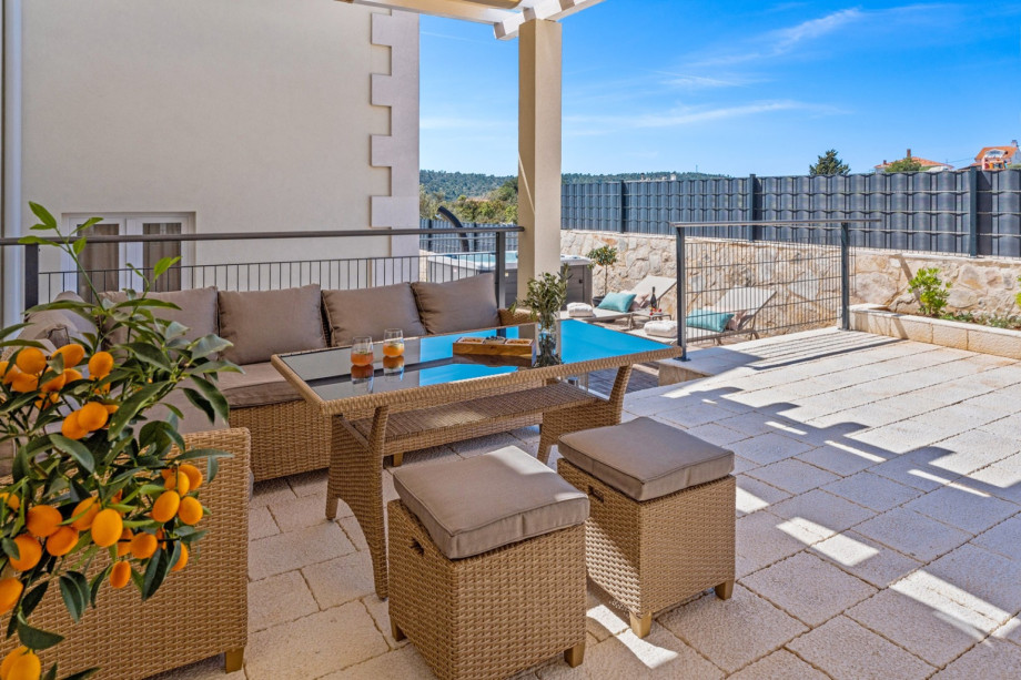 Covered lounge corner next to the pool.