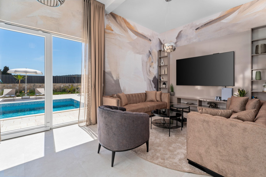 Stylish living and dining area with a direct approach to the outdoors (outdoor dining area and the pool).