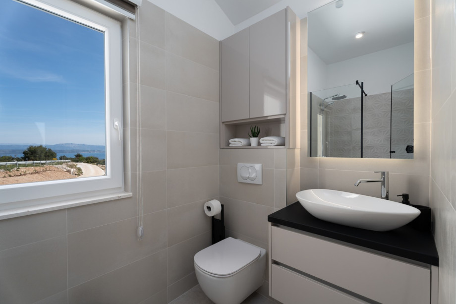 En-suite bathroom with a shower and a sea view
