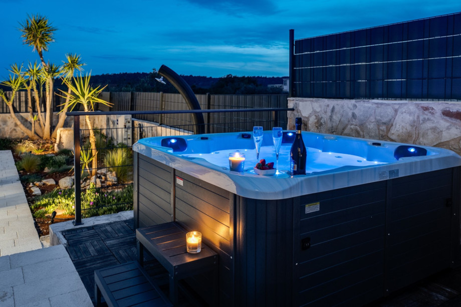 An outdoor hot tub for enjoying a glass of champagne.