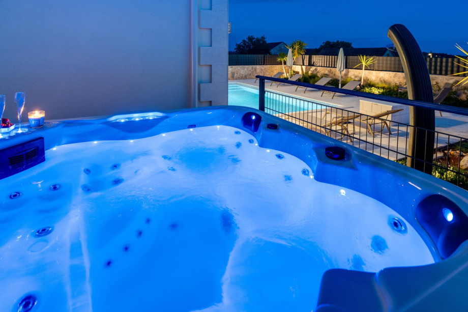 Hot-Tub (a Whirlpool) with a covered lounge corner next to it