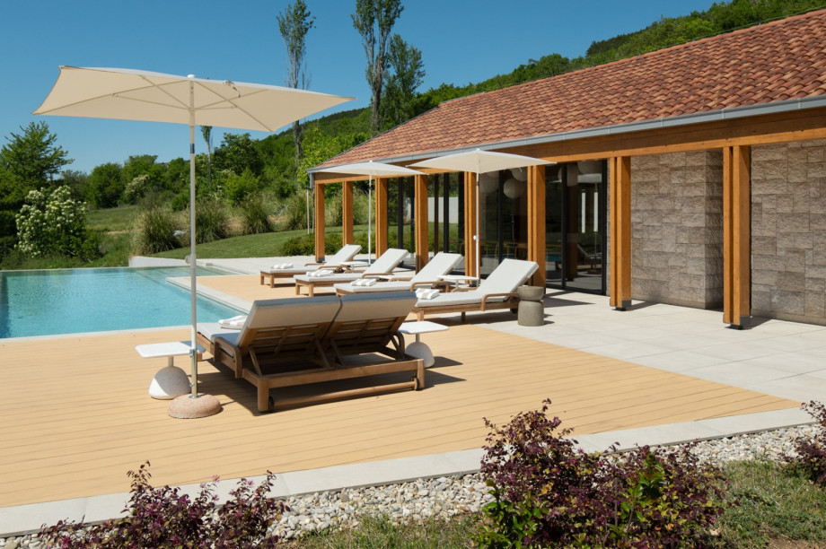 The sunbathing area is furnished with comfortable loungers, perfect for soaking up the sun.