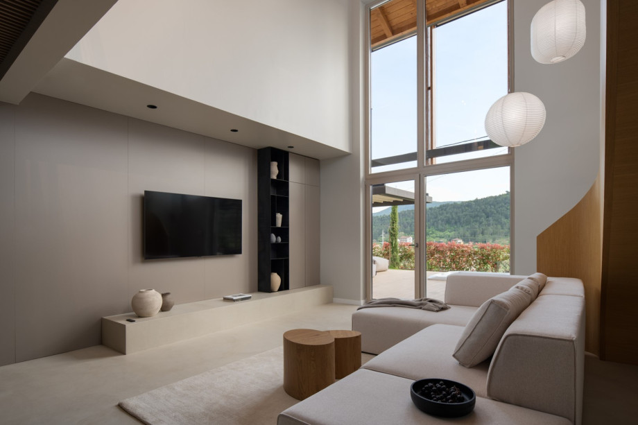 Expansive living room with floor-to-ceiling windows offering views of the tranquil Dalmatian landscape.