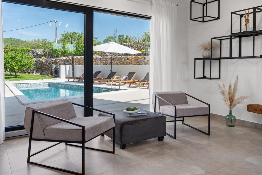 open space concept of living and dining area with pool views, fully equipped