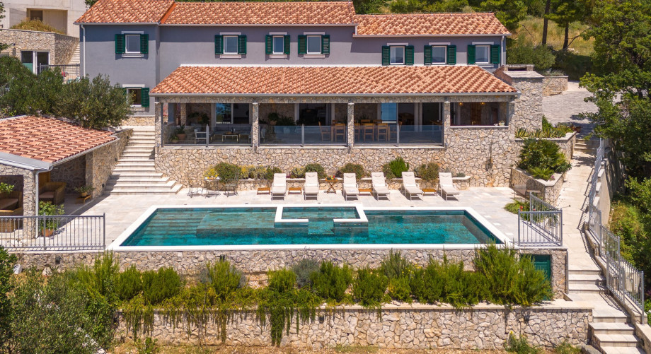 Sun deck area with 6 deck chairs, 2 sun umbrellas, and a  sitting corner