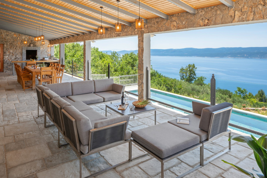 Outdoor dining area with a barbecue .