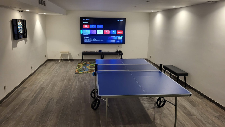 Media room with a table tennis and some toys for the youngest .