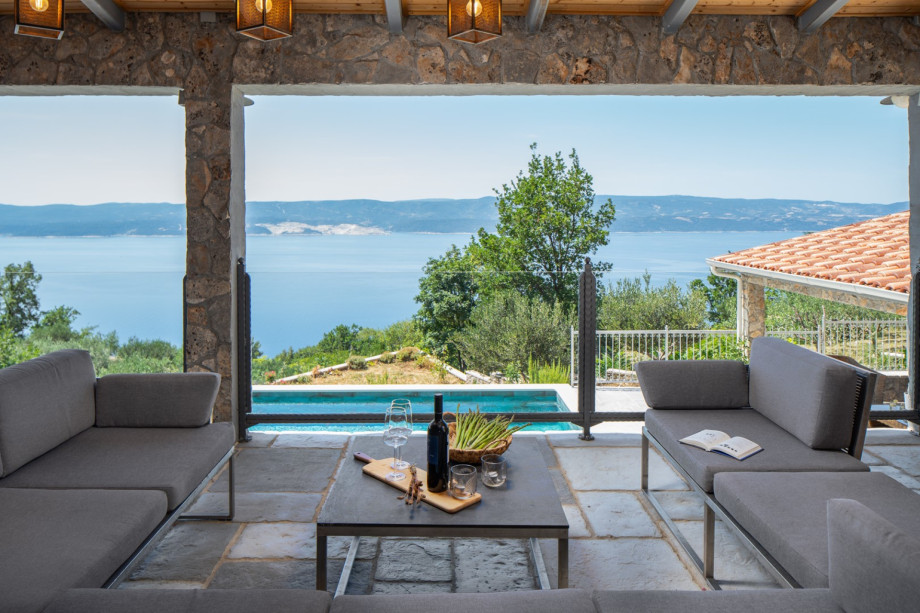 A gorgeous heated private pool with hydromassage and a covered lounging area