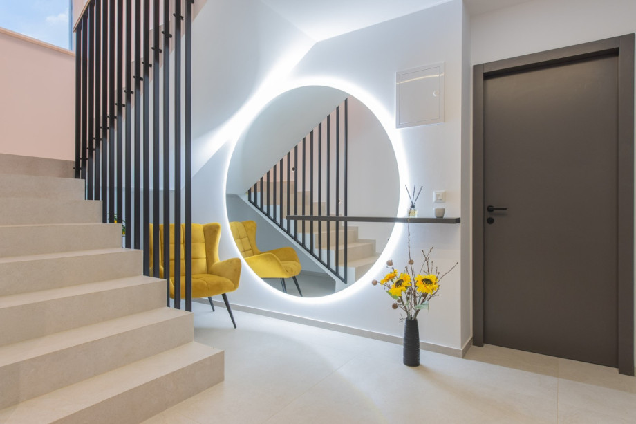 Modern interior detail with stylish seating, staircase design, and ambient lighting inside Villa River Rose.