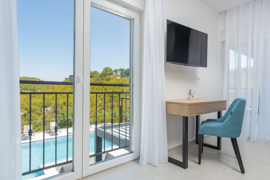 Private balcony for a first-floor bedroom, offering spectacular views of the pool and the natural surroundings.