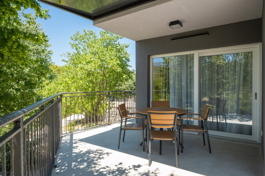 The villa includes a terrace with a dedicated outdoor seating area for four people.