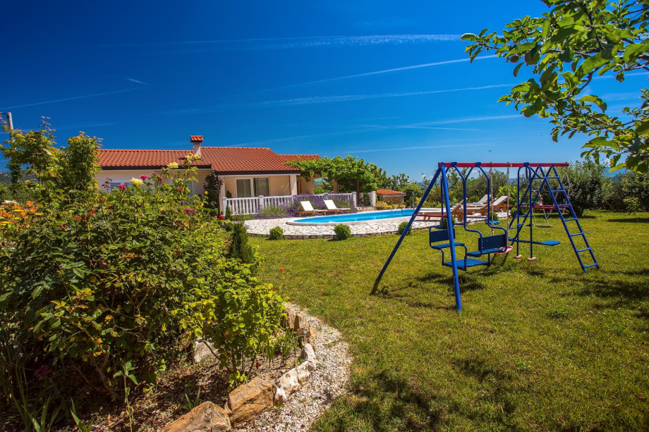 Kid's playground next to the pool area, surrounded with a beautiful nature.