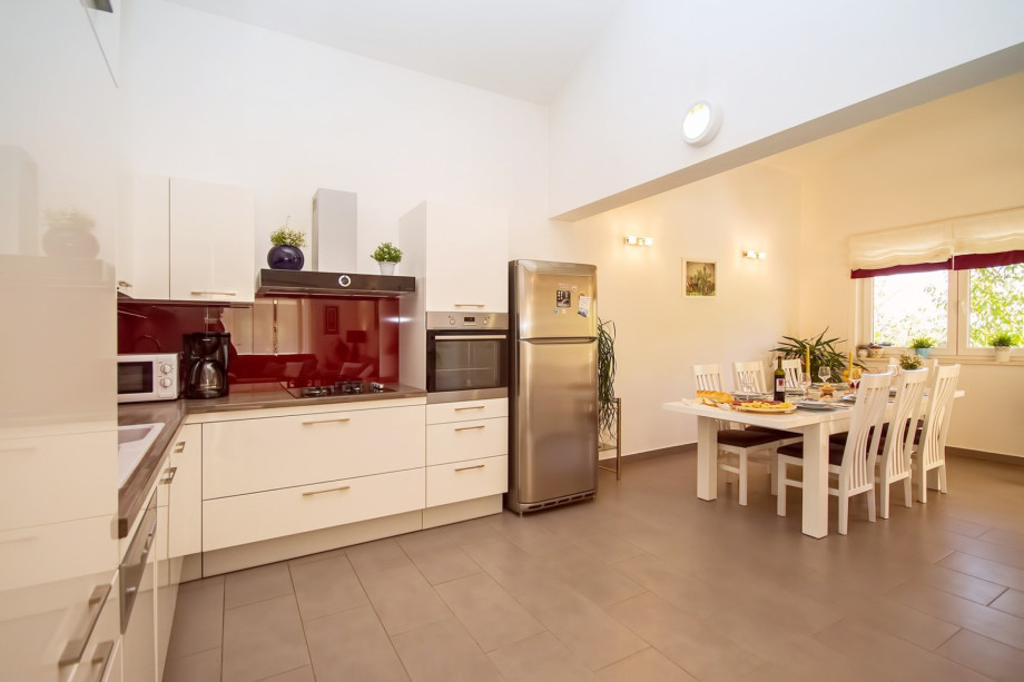 Fully equipped modern kitchen and big spacious dining table for 8 persons.