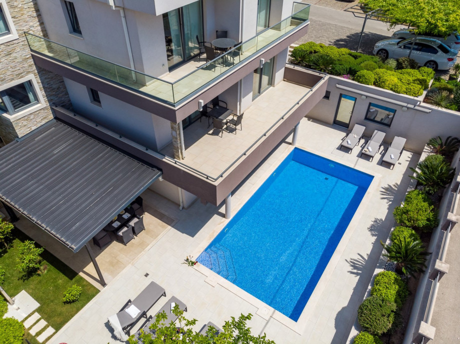 Private, heated 8x4m pool with 8 comfortable lounge chairs and outdoor furniture