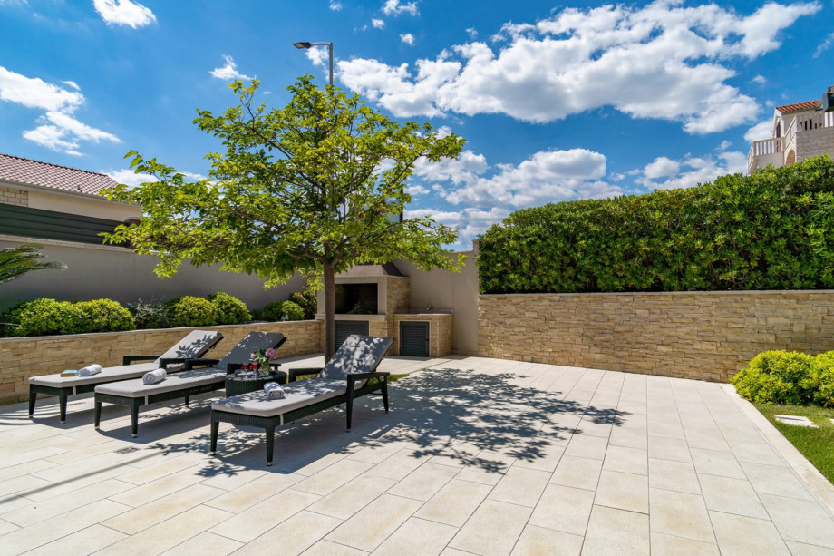Traditional grill next to the pool and outdoor dining area