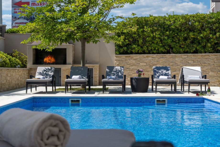 Private, heated 8x4m pool with 8 comfortable lounge chairs and outdoor furniture