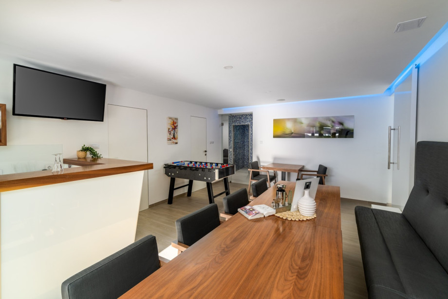 Conference room/fun zone with TV, table football, room with a running trail