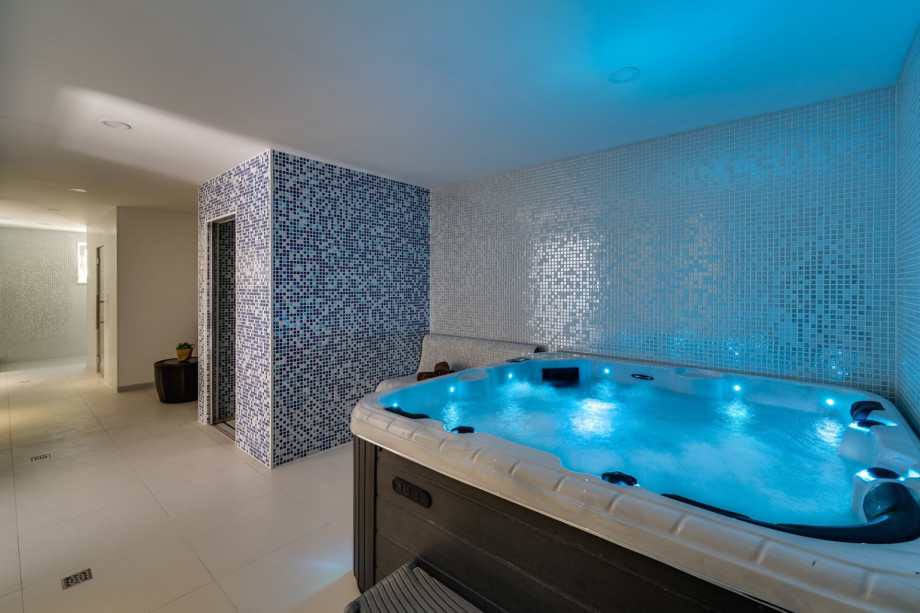 Luxurious spa area with steam room, shower, and whirlpool