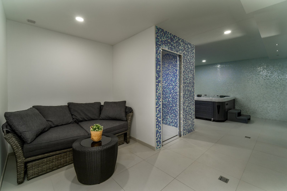 Luxurious spa area with steam room, shower, and whirlpool