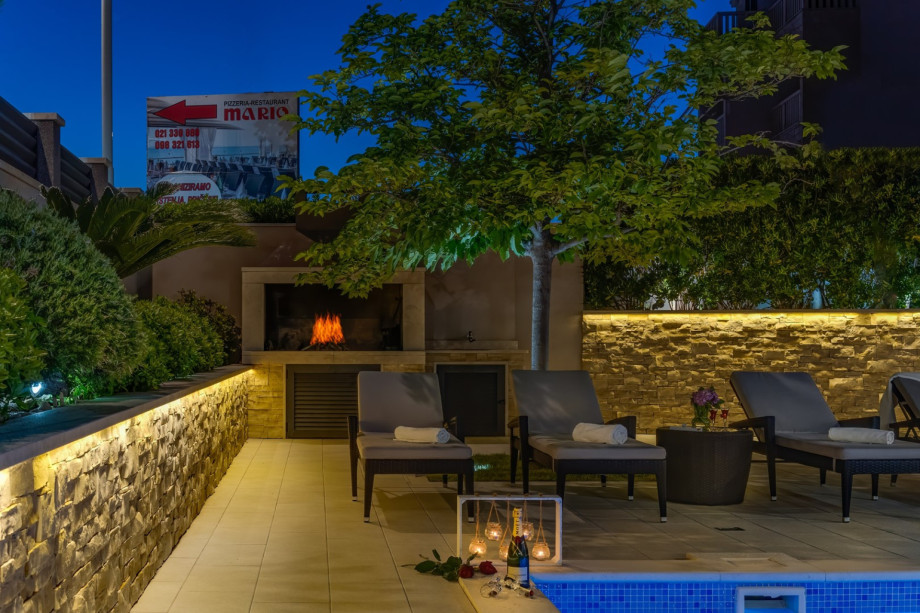 Traditional grill next to the pool and outdoor dining area