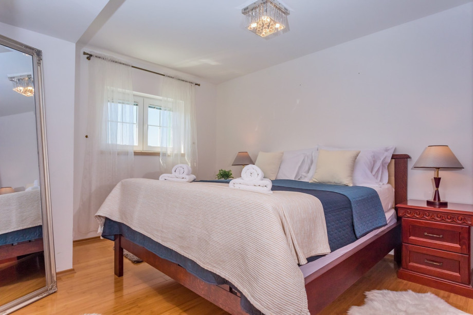 Bedroom No.2 with double bed, TV, and en-suite bathroom with shower (pool level)